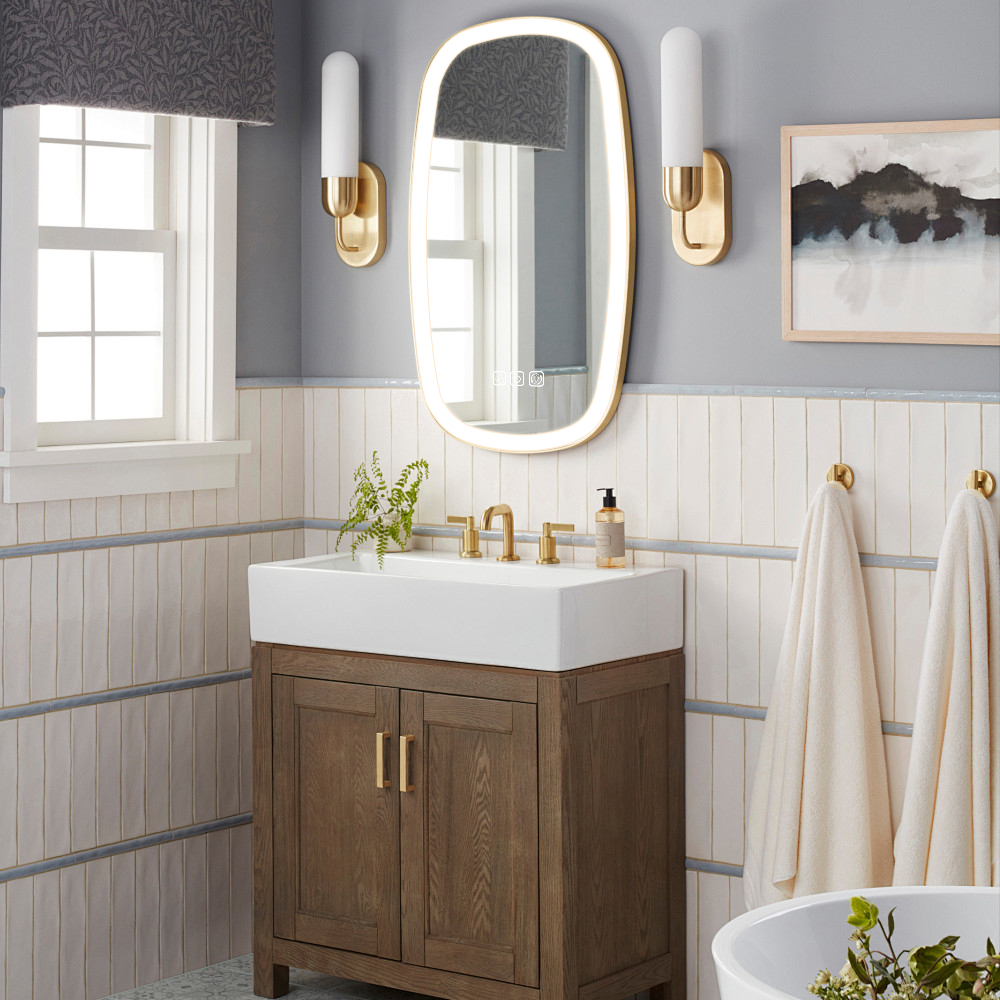 Los diseños de forma ovalada iluminan el espejo de baño LED con luces de tres colores