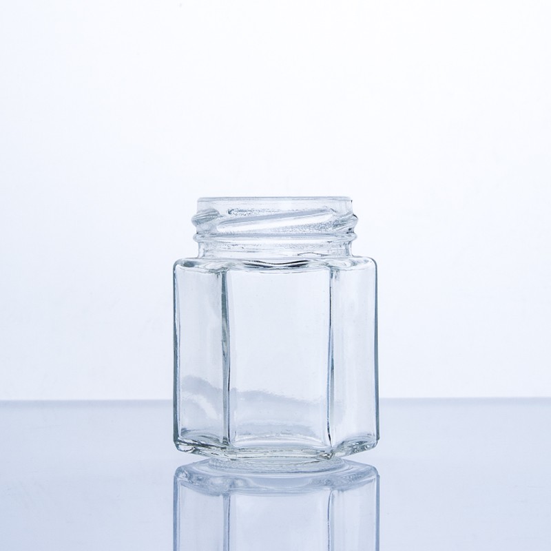 Sechseckiges Honigglas aus lebensmittelechtem Glas