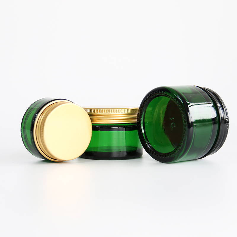 Leere, durchsichtige Glasbehälter, nachfüllbare Kosmetikfläschchen, Cremetiegel aus Glas mit Golddeckel