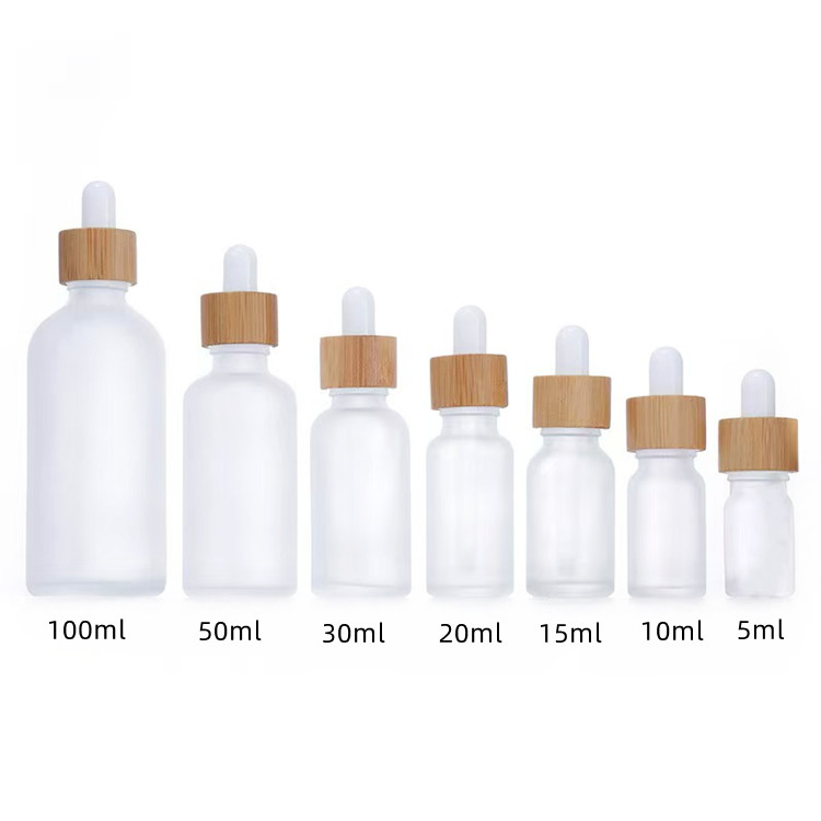Botol penetes kaca buram dengan tutup bambu ukuran 0,5oz dan 1oz untuk kemasan minyak esensial perawatan kulit.