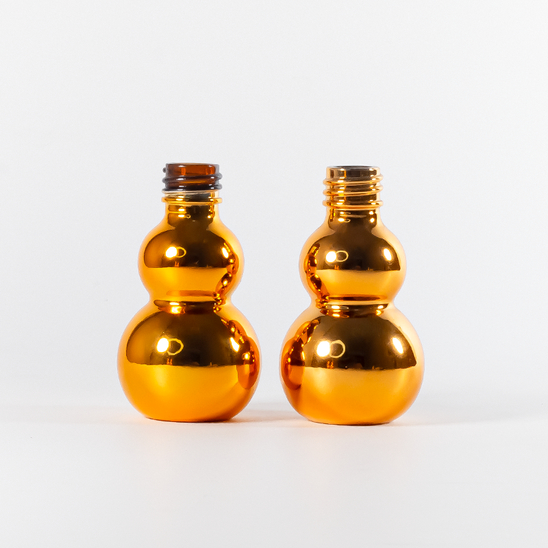 Flacon compte-gouttes en verre doré électroplaqué en forme de gourde, avec bouchon à œillet et ouverture facile anti-fuite.