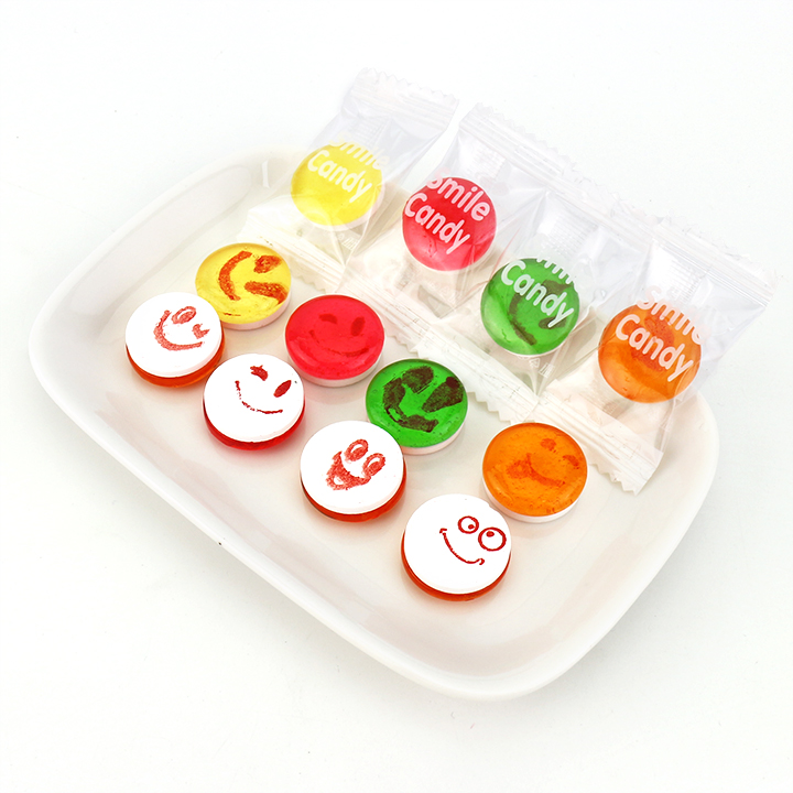 Supply 2-in-1 smile face fruit flavored hard candy with