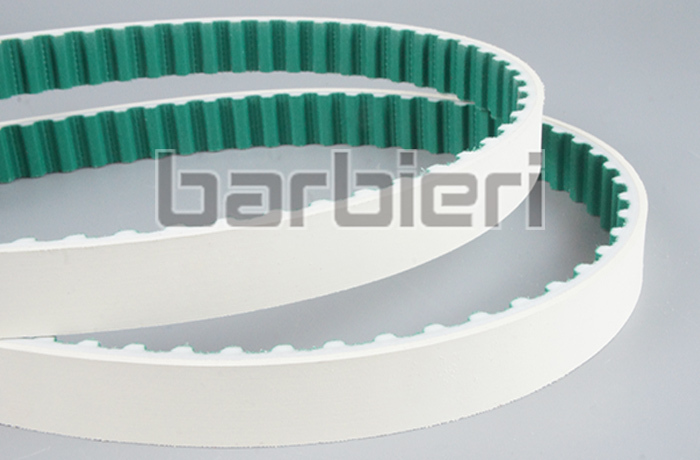 Timing belt tooth surface with polyamide fabric
