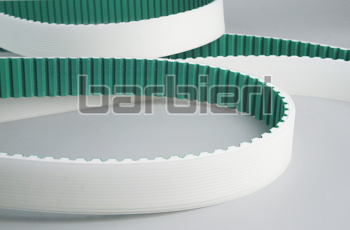 Timing belt tooth surface with polyamide fabric