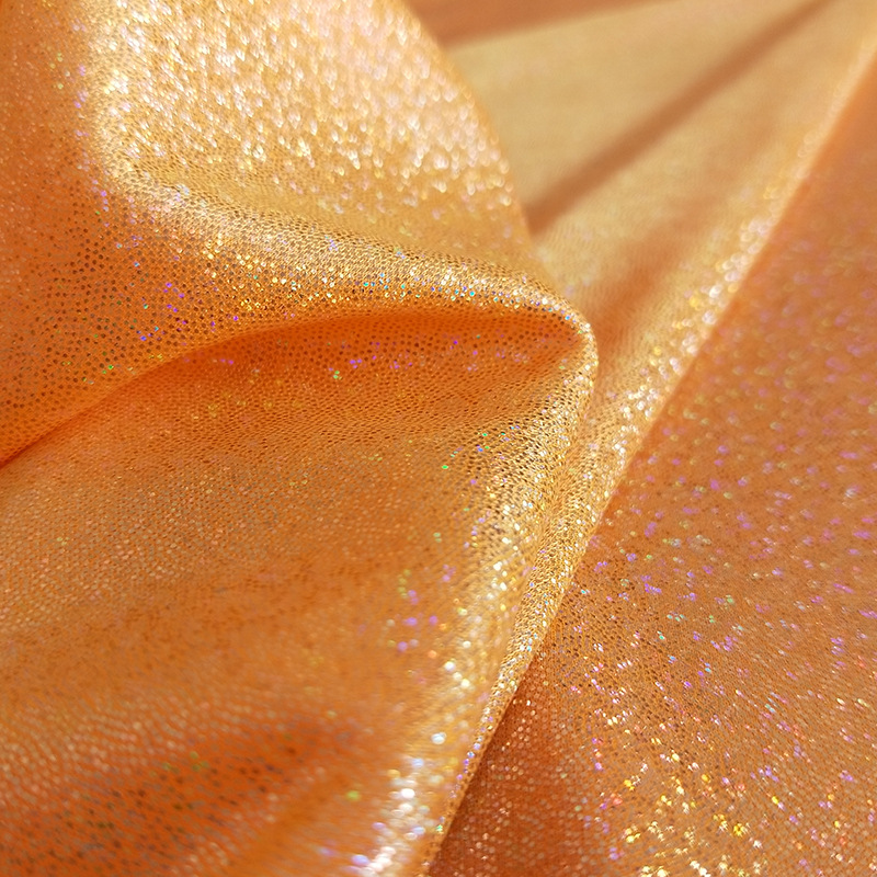 Китай Готовая к отправке блестящая бронзовая вязальная ткань красочная волшебная цветная лазерная фольга для тиснения сценической ткани голографическая ткань, производитель