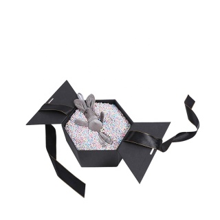 Caixa de presente hexagonal de fita vermelha