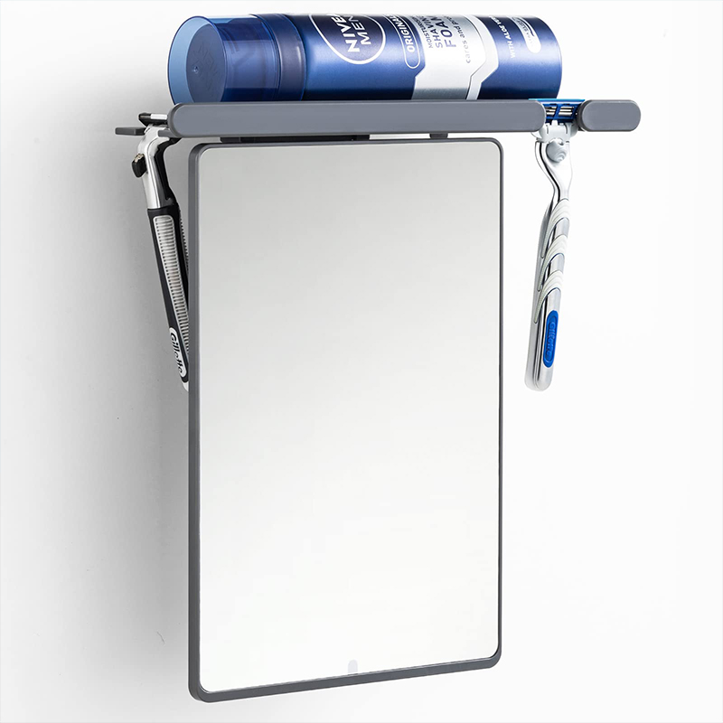 Fogless shower mirror with razor holder