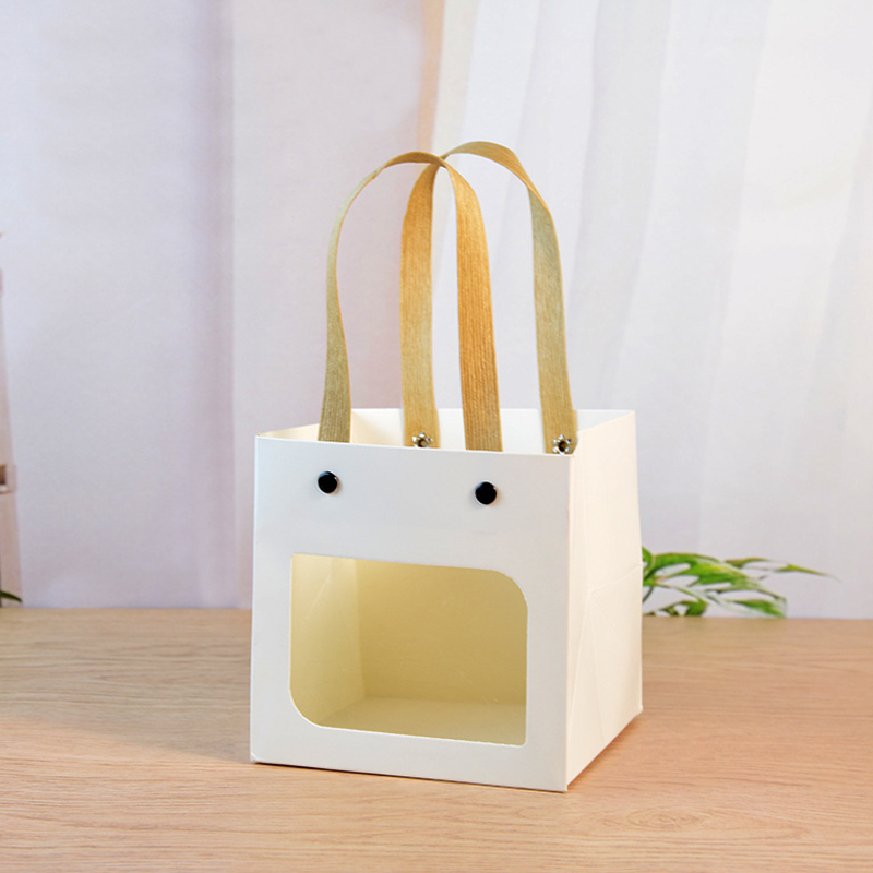 Sacs en papier de cadeau de festival coloré d'artisanat de poignée de rivet avec la fenêtre ouverte