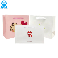 Sac en papier commercial de luxe blanc de haute qualité personnalisé avec emballage de sac cadeau logo avec poignées logo pour vêtements
