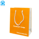 Luxury craft tote shopping paper packaging bags with logo print orange clothing cosmetic hair gift bag for small businesses