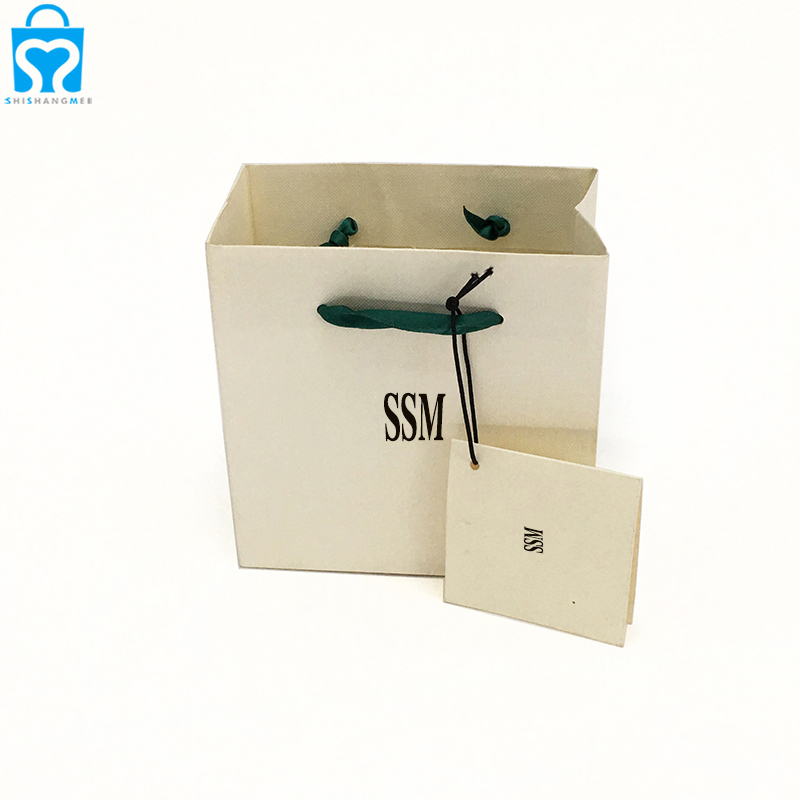 Petit emballage de sac de golf recyclable en papier cadeau blanc avec poignées en ruban vert pour emballage décoratif de bijoux