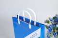 Euro tote pequena laminação azul brilhante bem-vindo saco de presente de compras de papel comercial com seu próprio logotipo