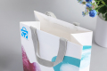 Европейский бутик, раскрашивающий косметические туалетные принадлежности, бумажные хозяйственные сумки для макияжа с ручкой из ленты