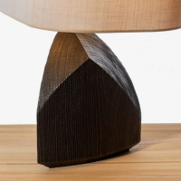 A lamp featuring an artistic shape and a wooden base