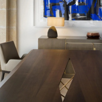 A lamp featuring an artistic shape and a wooden base