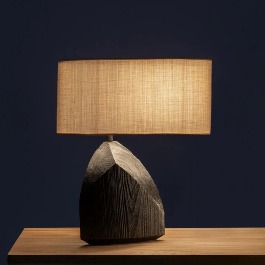 A lamp featuring an artistic shape and a wooden base