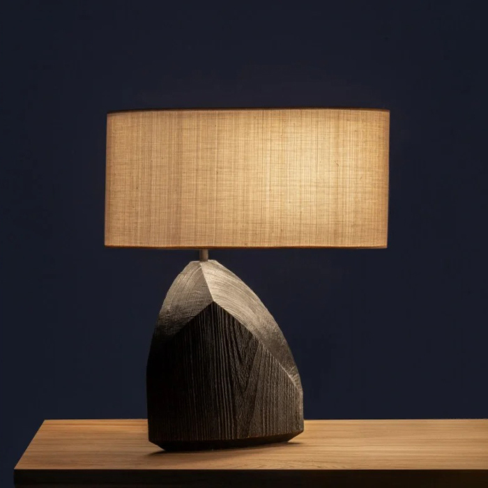 A lamp featuring an artistic shape and a wooden base