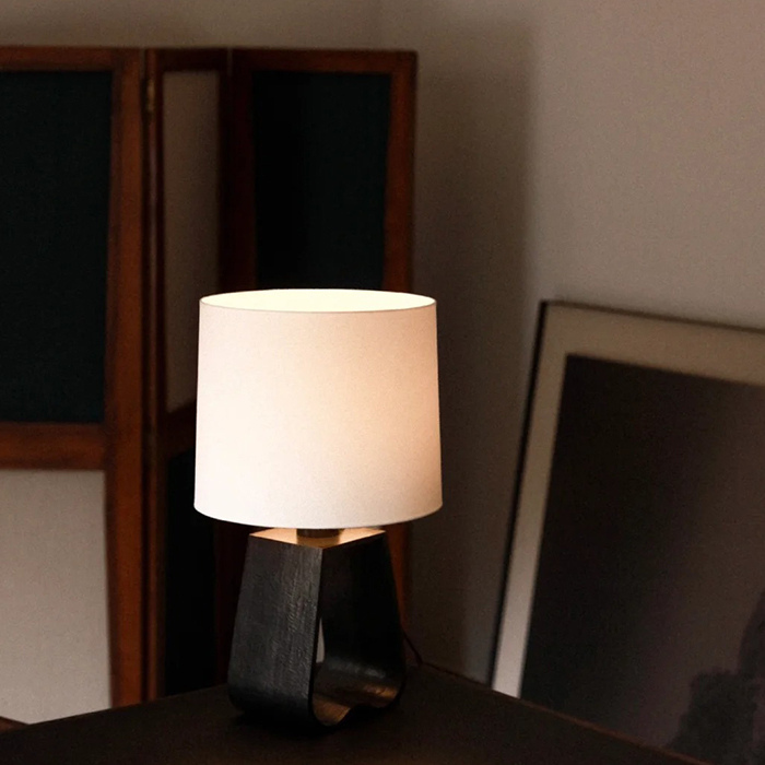 A minimalist desk lamp designed in black and white color tones.