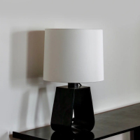 A minimalist desk lamp designed in black and white color tones.