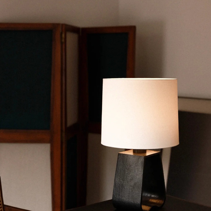 A minimalist desk lamp designed in black and white color tones.