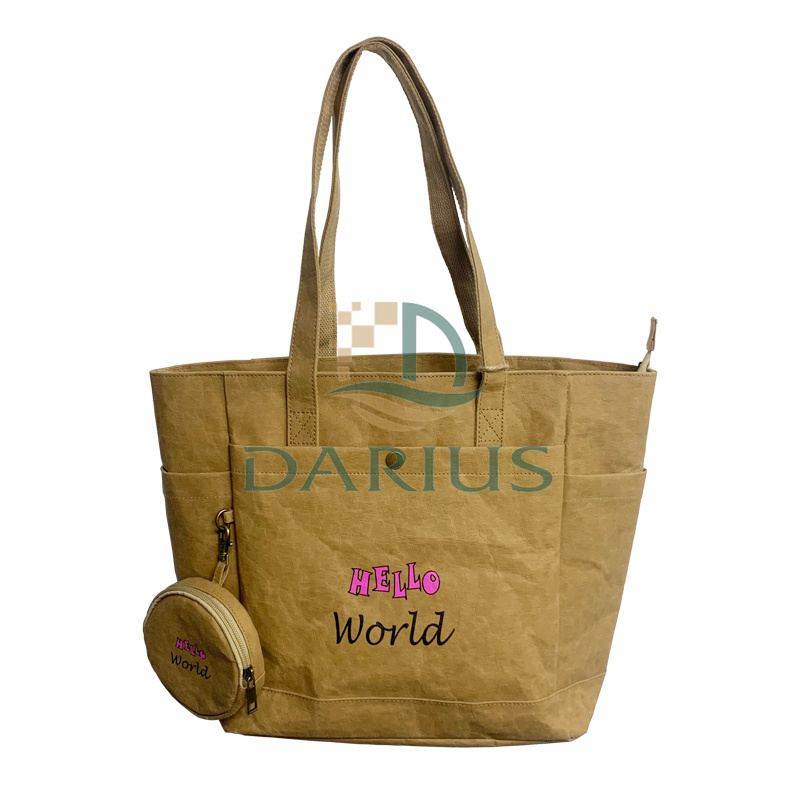 Ruskea voimapaperivetoketjullinen ostoslaukku pienellä pyöreällä laukulla