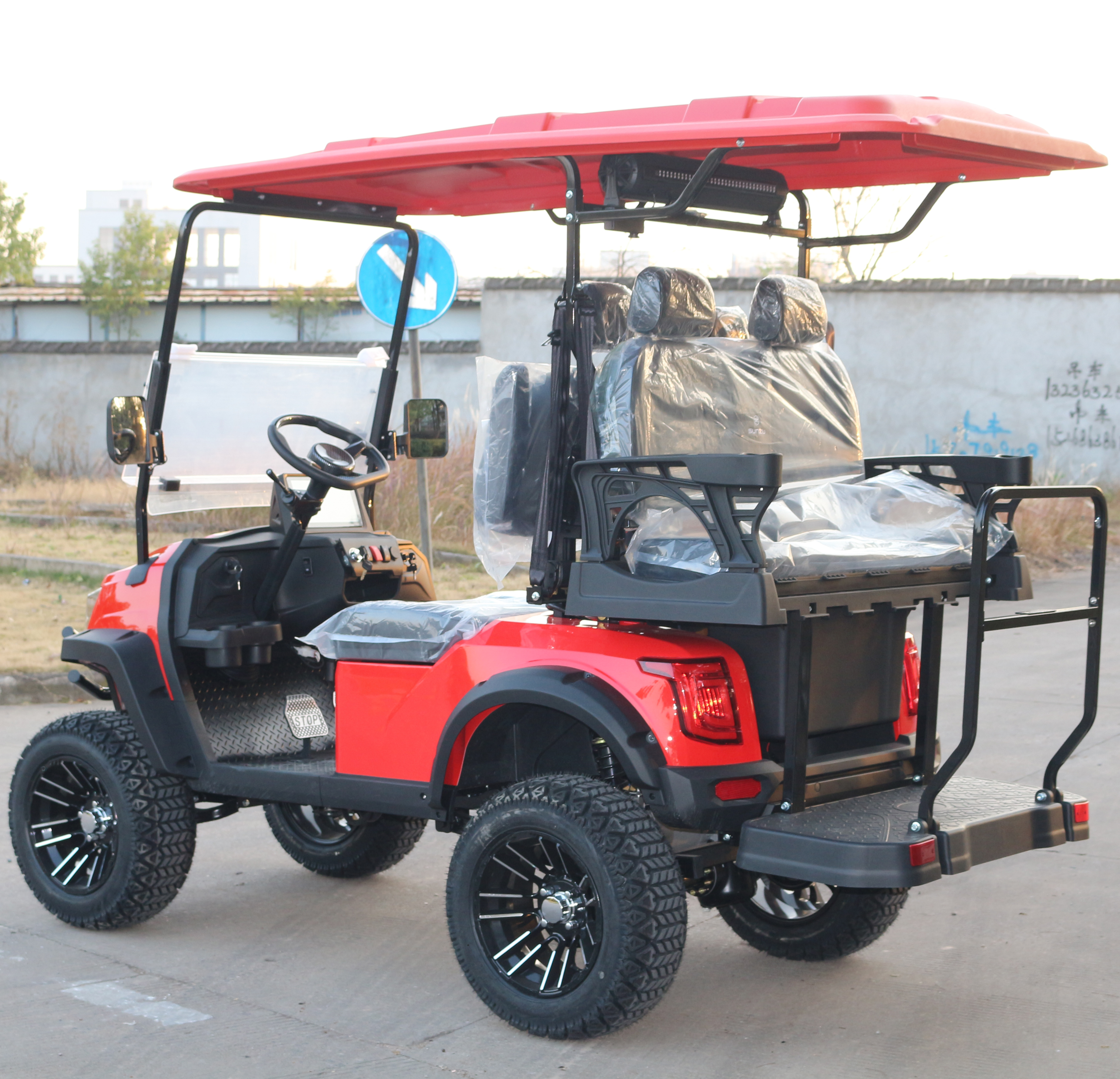 4-Seat Red Golf Cart with Rugged Tires for Beach Leisure Rides