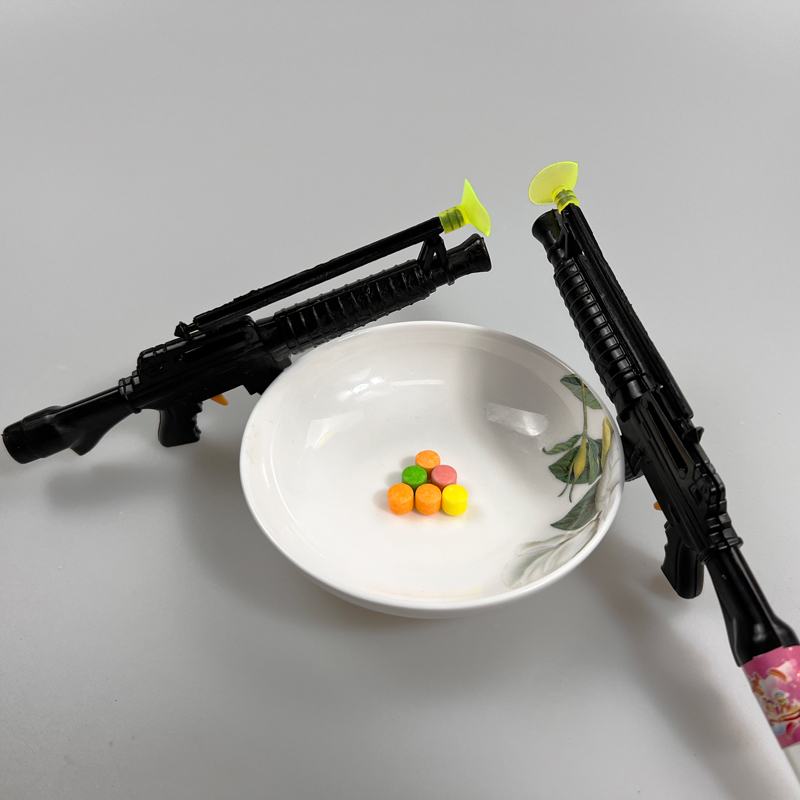 Boys favorite toy gun with multicolored fruity hard pressed candy