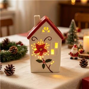 Kerstster met hol, verlicht keramisch huisje met rood dak, decoratieve LED-figuur voor een feestelijke sfeer.