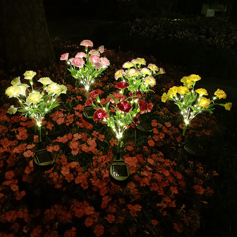 Luces de estaca con flores de clavel artificiales solares