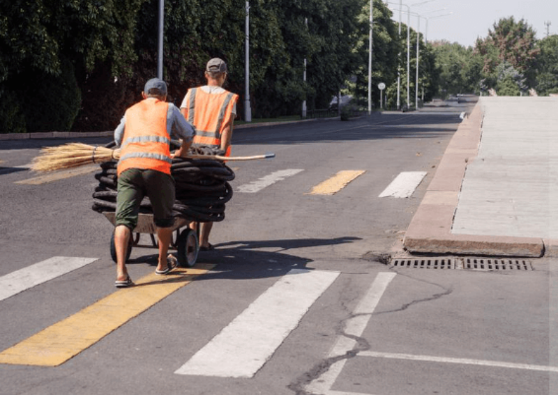 Employees deliver water to sanitation workers in hot summer