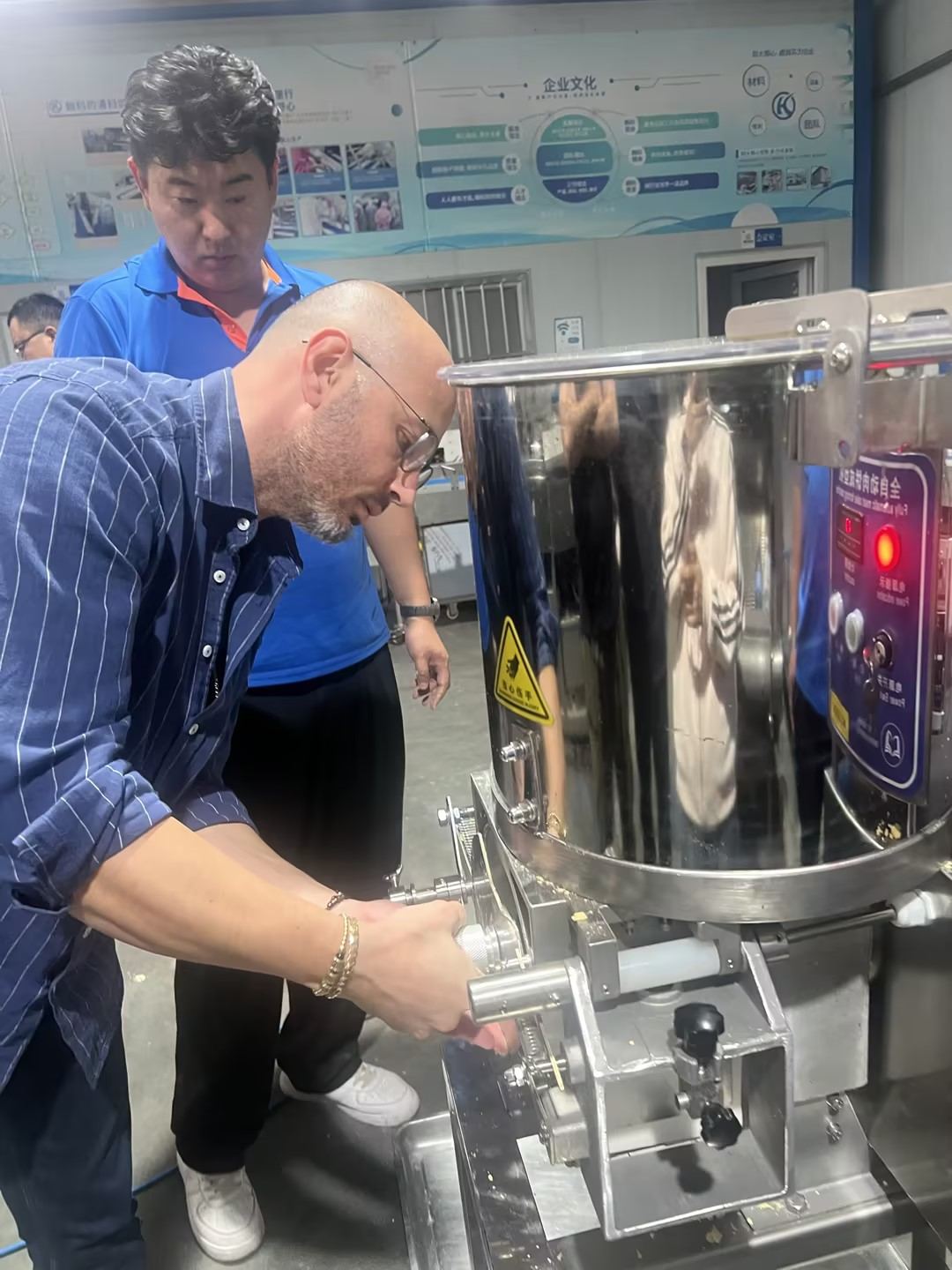Customer adjusting the forming head of the patty forming machine during the trial