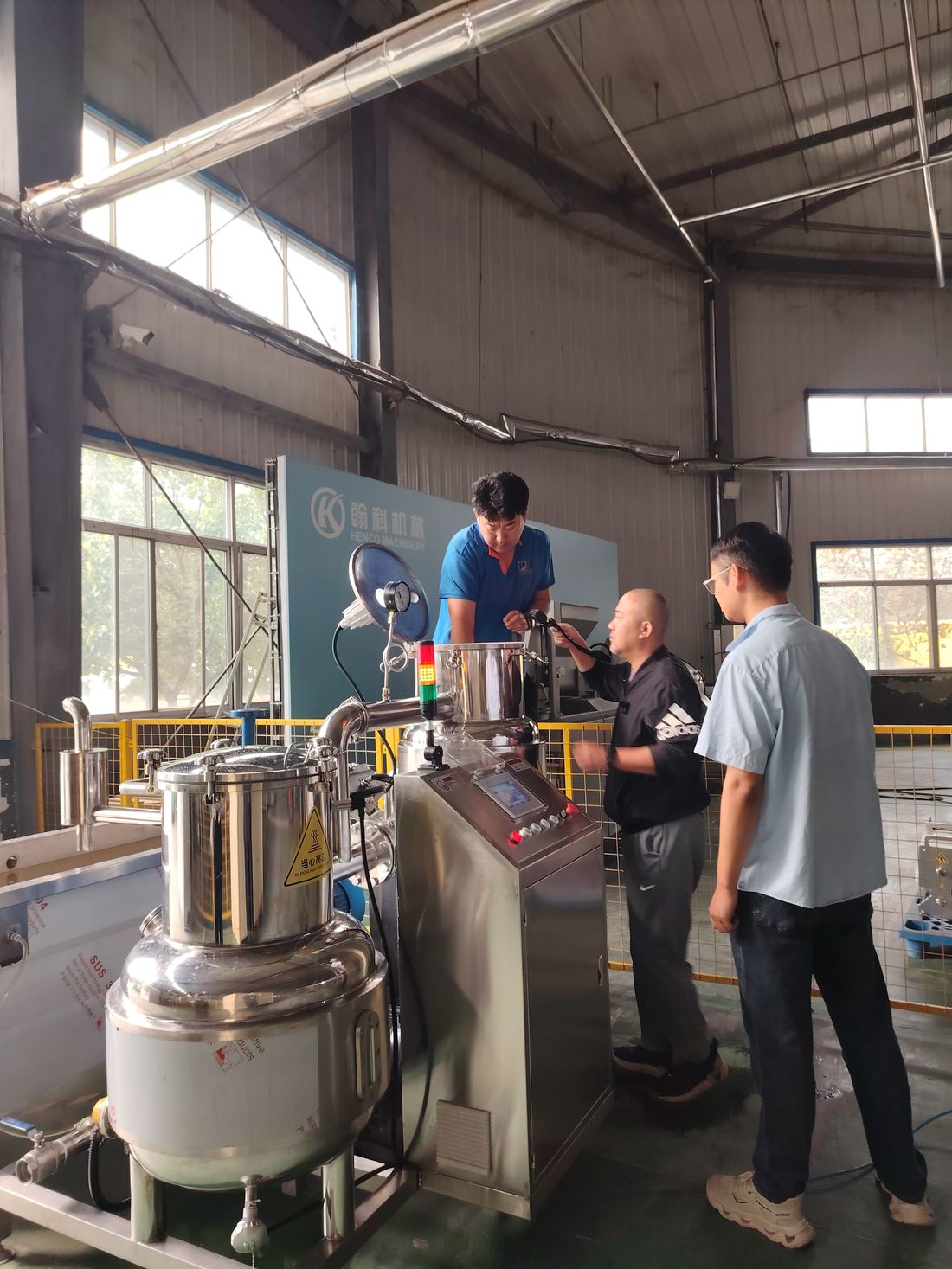 Henco engineer explaining the control panel to the customer's operators during training