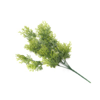 The Table Is Decorated With Artificial Greenery