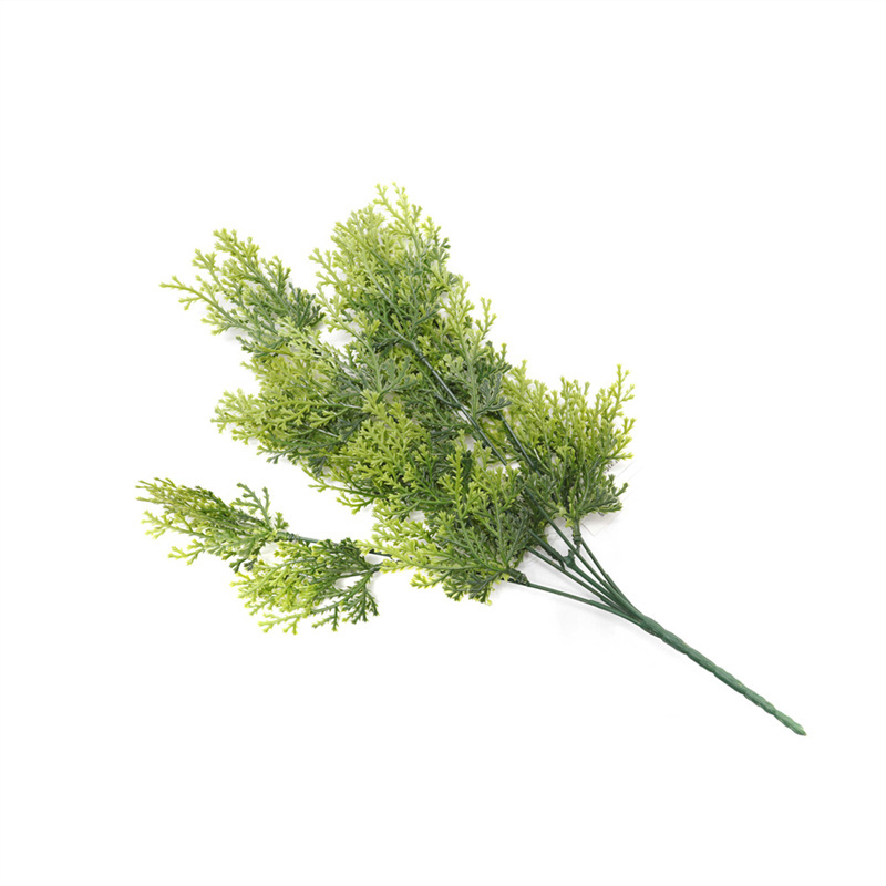 The Table Is Decorated With Artificial Greenery