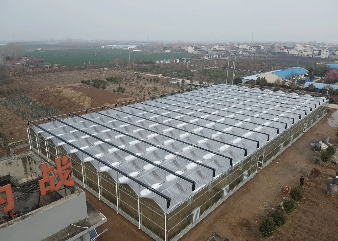 What costs are involved in building a glass greenhouse?