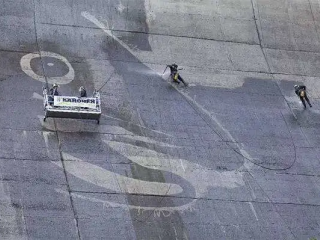 Artist uses high pressure washer to paint