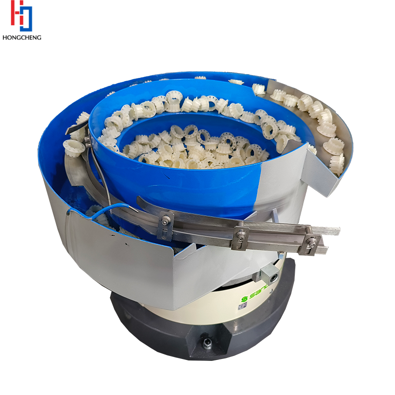 Vibrating bowl feeder for feeding rubber