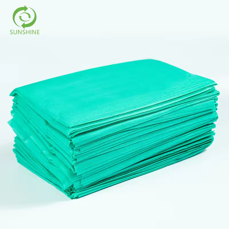 Raw materials for factories disposable nonwoven spunbond fabric 100% polypropylene fabric perforated medical bedsheet insulation