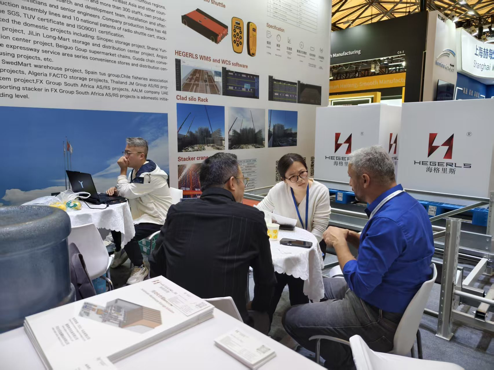 HEGERLS engineers discussing warehouse automation trends with global clients HEGERLS engineers discussing warehouse automation trends with global clients