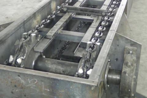 What is a conveyor scraper?