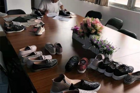 Our colleague peter is comparing the color swatch with women leather shoes carefully